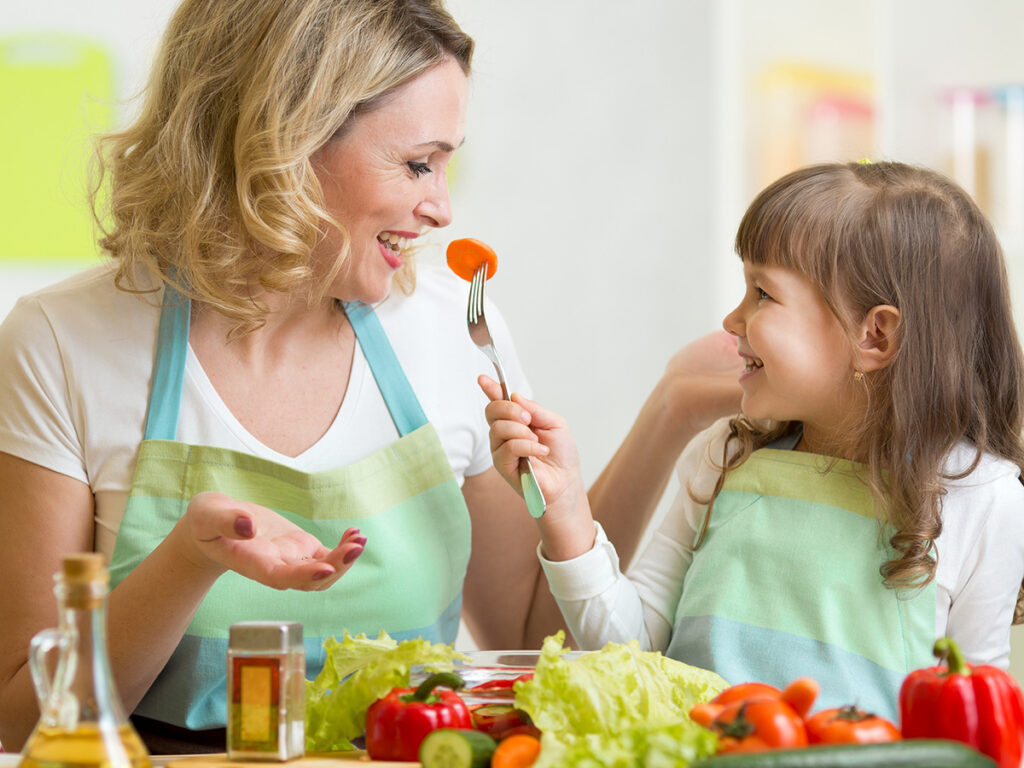 Teacher and student preparing a healthy meal.